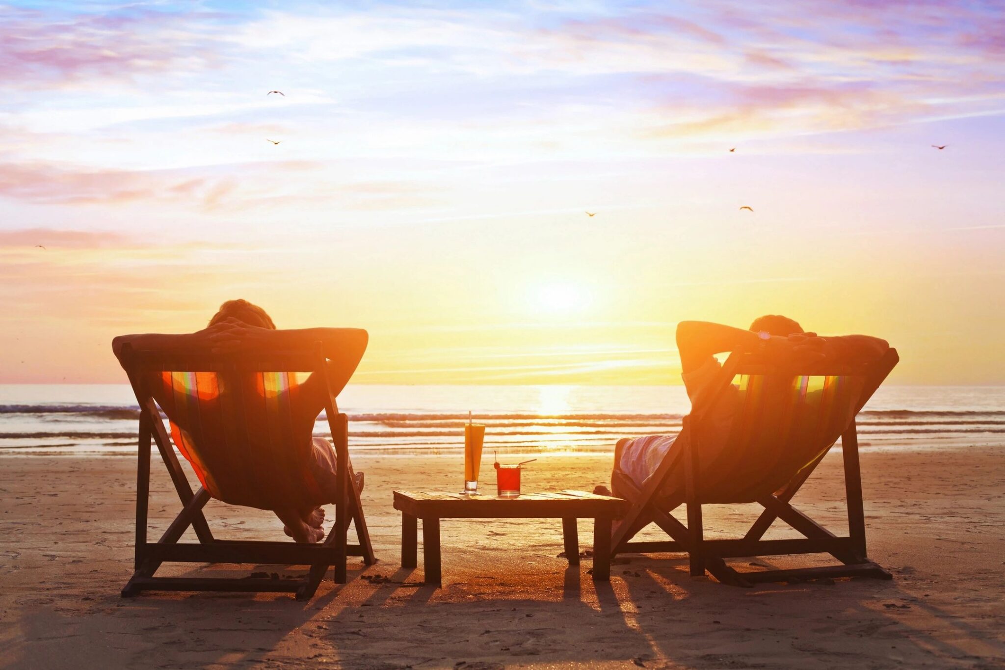 Beach lounge chairs overlooking the sunset at an adults-only all-inclusive resort