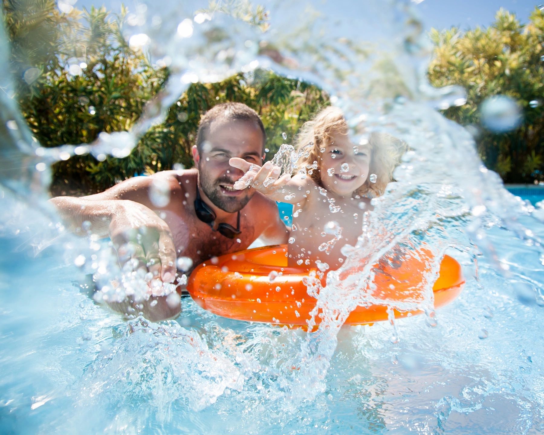 Parent and child playing in the water at a family-friendly all-inclusive resort